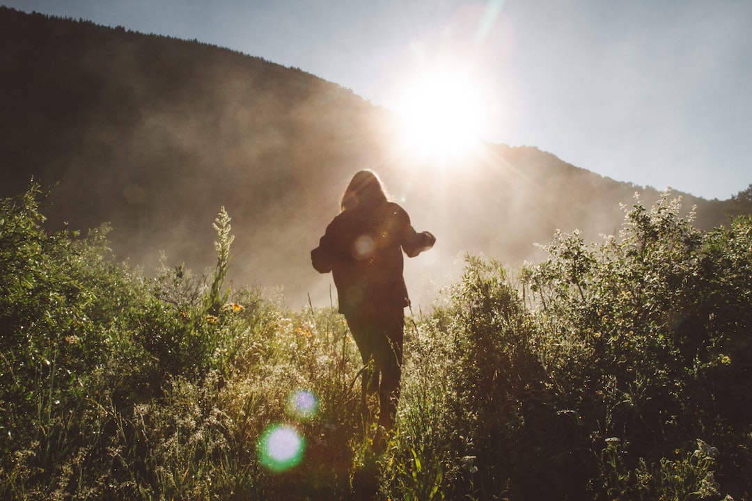 An image showcasing a hiker conquering a rugged mountain trail, muscles flexed, sweat dripping, as they powerfully ascend a steep slope, surrounded by breathtaking natural scenery