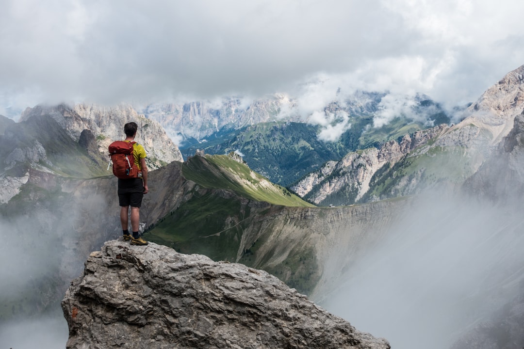 An image showcasing a rugged mountain trail with a hiker in well-fitted boots effortlessly trekking uphill