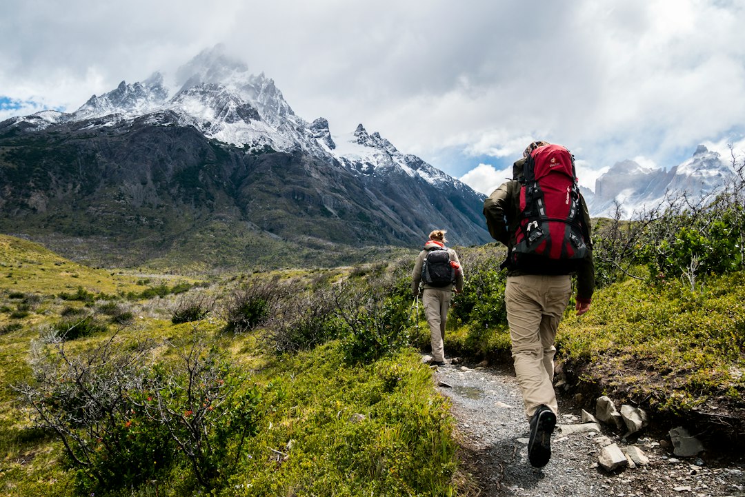 An image capturing the breathtaking Trilha Praia Do Perigoso hike: a rugged trail leading through lush rainforests, steep cliffs offering panoramic ocean views, and finally, a secluded beach nestled amidst dramatic rock formations